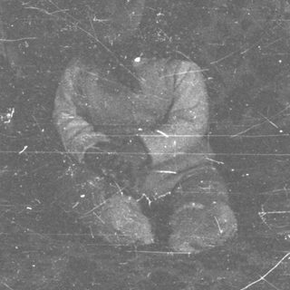 Film strip with a blurred figure sitting within it.