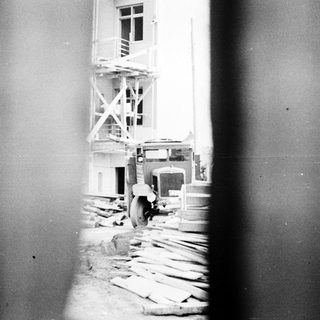 Construction site with scaffolding and a truck.