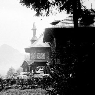 Historic building overlooks landscape with a mountain in the distance.