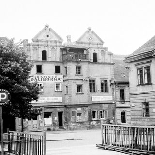 Black and white photo of a hotel and street scene.
