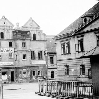 Black and white photo of a hotel and street scene.