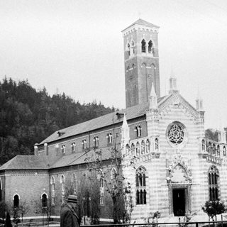 Black and white image of a church with a tall tower.