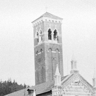 Black and white image of a church with a tall tower.