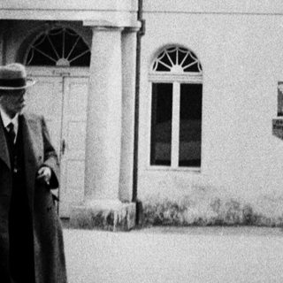 Black and white photo of a building labeled "Milchtrinkhalle."