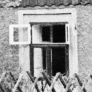 Black and white image of a timber-framed building.