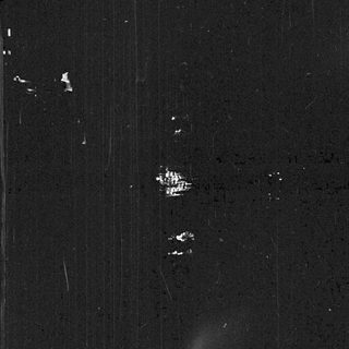 Nighttime image shows distant lights and dark silhouettes.
