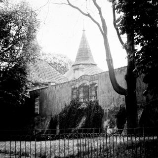 Black and white image of a building with a spire.