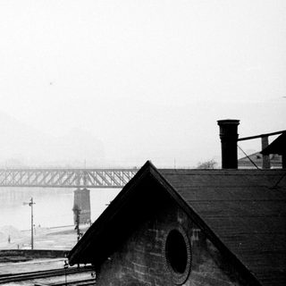 Industrial landscape with a bridge and a misty background.
