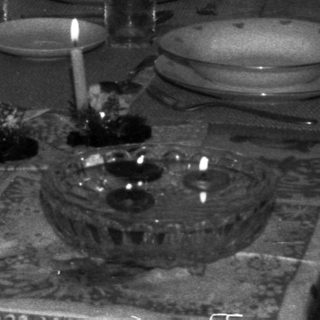 Boy sits at a formally set table with candles.
