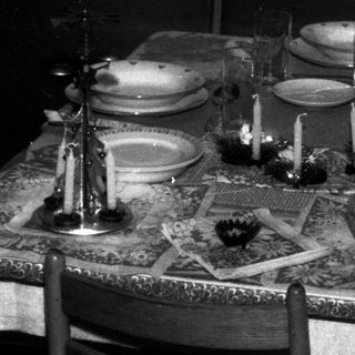 A formally set table with chairs in a room.