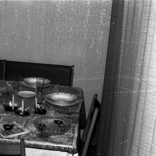 A formally set table with chairs in a room.