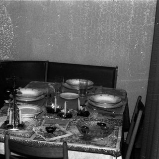 A formally set table with chairs in a room.