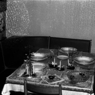 A formally set table with chairs in a room.