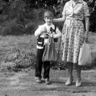 Black and white photo of a woman and child standing outside.