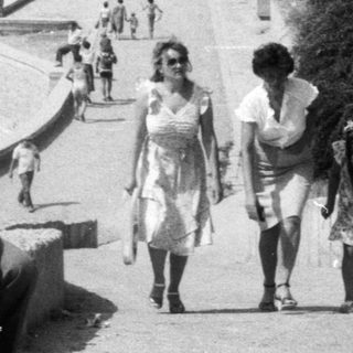 Black and white image of a beach scene with people.