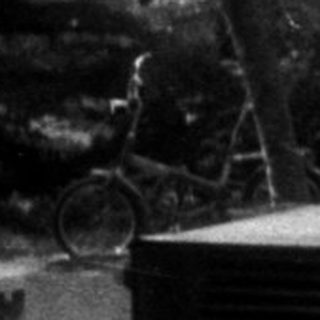 Vintage miniature train with a child standing nearby.
