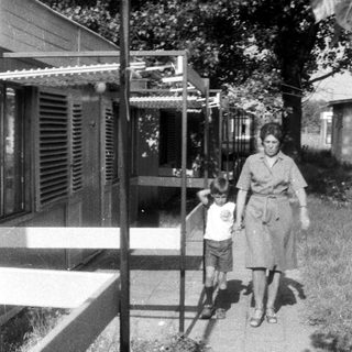 Woman and child walk along a paved path.