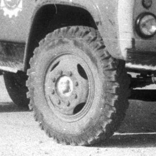 Black and white image of a vintage dump truck.