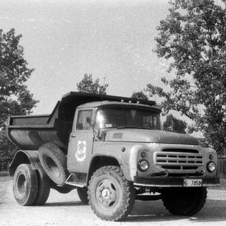 Black and white image of a vintage dump truck.