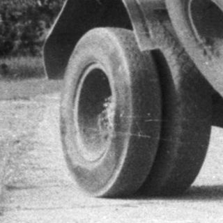 Black and white image of a vintage dump truck.