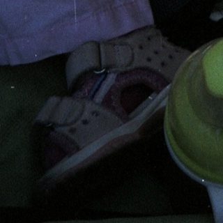 Baby sleeps peacefully in a stroller with toys.