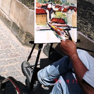 Baby in stroller near artist painting outdoors.
