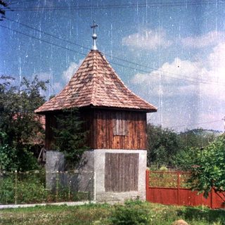Wooden structure with a cross sits on a concrete base.