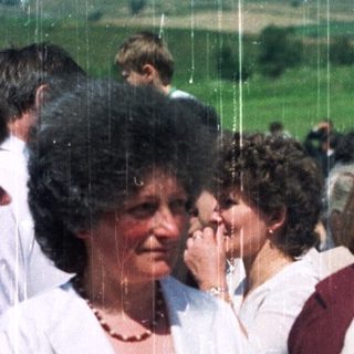 Group of women in traditional dress outdoors.