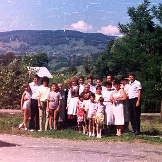 Group portrait outdoors, likely a family or community gathering.