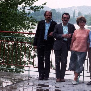 Group of people standing near a body of water.