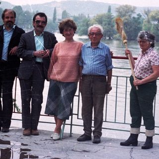 Group of people standing near a body of water.