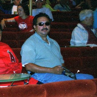 Group of people seated in tiered, red stadium-style seating.