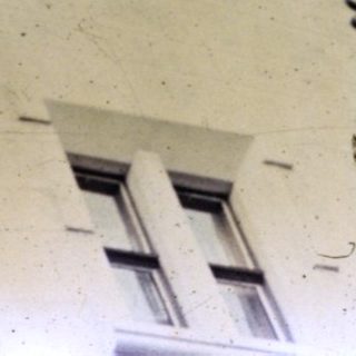 Close-up of an ornate, arched building facade.