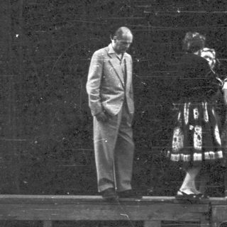 Group of people on a stage, possibly performers.