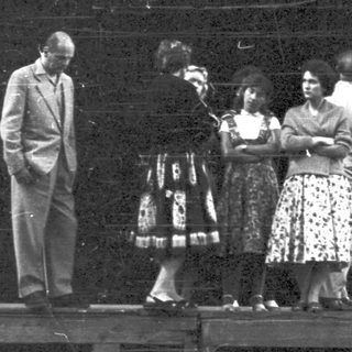 Group of people on a stage, possibly performers.