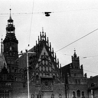 Black and white image of a historic building with a clock tower.