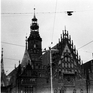 Black and white image of a historic building with a clock tower.
