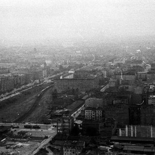 Aerial view of a city, obscured by smoke or fog.
