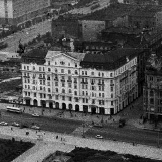 Aerial view of a city with grand buildings and streets.