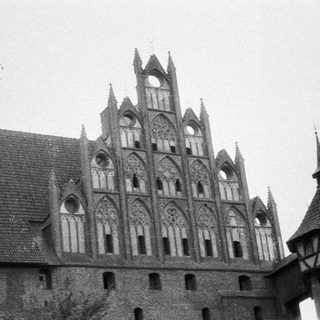 Black and white photo of an old, ornate, timber-framed building.