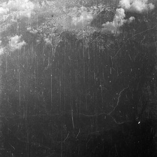 Volcanic landscape and clouds, captured in a vintage photograph.