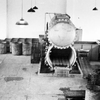 Vintage industrial scene featuring a large, complex machine.