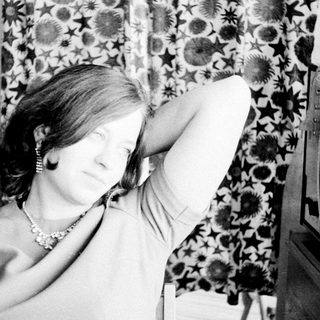 Woman holds her hand up to her armpit.