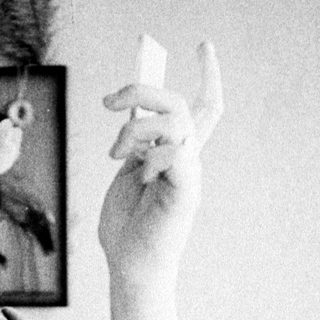 Woman looking in a mirror, examining her face.
