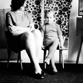 Woman and child seated, posing for a black and white portrait.