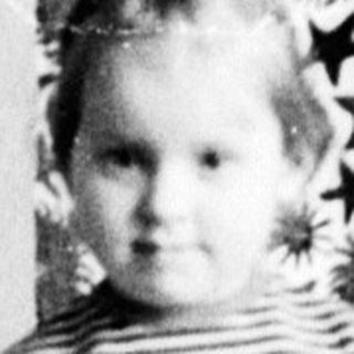 Woman and child seated, posing for a black and white portrait.