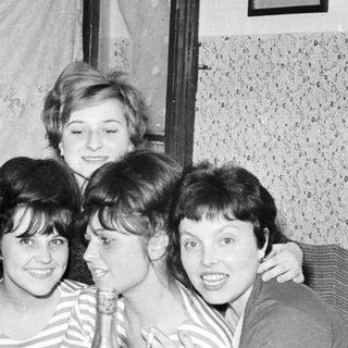 Group of women smiling and posing for a photo.