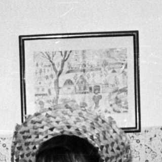 Group of women playfully wearing hats and smiling.