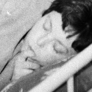 Here's a brief summary: Baby sleeping in a crib, appearing peaceful and still.