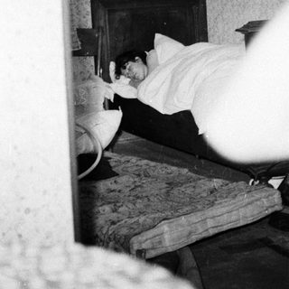 Person sleeping in a bed inside a room.